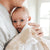 Baby held by father in keepsake heirloom lace edge blanket